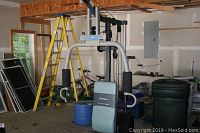 Full view of the Marcy Platinum weight machine in garage setting among other stored items