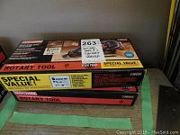 Image showing two Craftsman rotary tool boxes stacked on green tape lines. Top box is model 936055 and includes accessories with factory sealed label. Bottom box is model 936053.