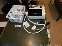 Full view of water ionizer unit with accessories in white basket