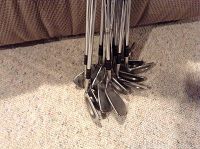 Several refurbished Lynx golf irons, numbers 1 through 9 plus P, LW, SW, with chrome finish and steel shafts, black rubber grips.