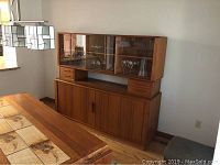 Full front view of the two-piece buffet breakfront with glass-front display hutch