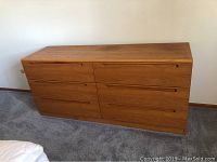 Front view of the six drawer wooden chest showing balanced drawer layout and smooth finish.