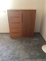 Front view of wood veneer chest showing five drawers on left and single-door cabinet on right