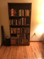 Front view of first bookcase fully stocked with books