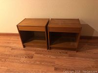 Front view of both nightstands side by side on hardwood floor against wall