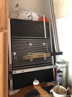 Full view of the tabletop of the Sears Craftsman table saw with fence and measuring guide laid flat against a wall.