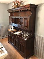 Front view of the full pine wooden hutch showing upper shelving, drawers, and cabinet doors with contents on top of lower cabinet (not included).