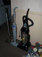 Three Bissell cleaning appliances: upright vacuum, steam mop, and sweeper lined up.