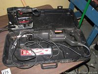 Craftsman Sabre Saw and Craftsman Reciprocating Saw in black, displayed inside and near their carrying case on a workbench.