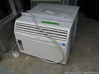 Front angle view of the Sharp window air conditioner showing size and remote on top.