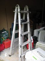 Full view of aluminum Gorilla Ladder folded in a compact step ladder configuration in garage.