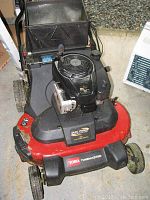 Front top view showing engine housing, cutting deck and wheels