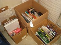 Photo showing three open boxes filled with assorted vintage board games and puzzle. Visible titles include Up Words, Bo Jangles, and others.