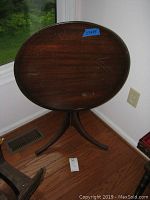 Photo of 23x25 inch round flip top table showing tabletop and scratches