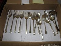 All flatware pieces in cardboard box