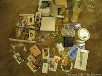Overview of full lot showing various religious items including plaques, crosses, cards, rosaries, and figurines.