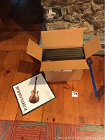 Box containing 6 shrink wrapped record album frames and one frame out of the box on the floor.