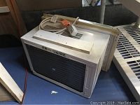 Side view showing Frigidaire branding, power cord, and adjustable side panels.
