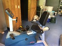 Side view of the Life Fitness recumbent exercise bike showing seat, pedals, and console.