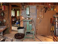 Front view of green Grizzly band saw installed in a garage workshop
