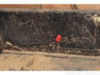 Close-up of the interior side of the trailer bed showing rust and wear.