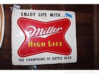 Full view of the metal sign showing the advertising text and logo