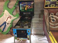 Full view of Williams pinball machine with blue cabinet and gopher-themed backglass