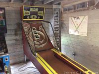 Front view of full skee ball machine showing scoreboard sign and playfield