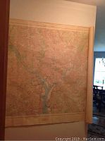 Overall view of large vintage map rolled on one side, showing full geographic coverage of Washington and surrounding area.