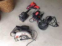 Overview of all power tools and water pump laid on the ground showing the tools' scale and condition.