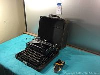 Royal touch control typewriter open in original case with new ribbon pack visible.