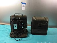 The complete Keystone Automatic 8mm projector set includes the projector and the black hard plastic carrying case with 'K' insignia.