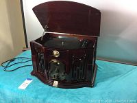 Open top view of the record player showing the turntable and wood cabinet