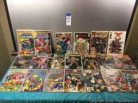 General layout of over a dozen comics in sleeves on table