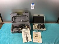 Closer view of Dremel MultiPro rotary tool inside gray case with flex shaft and accessory bits.