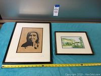 Two framed art pieces laid flat on table with measuring tape for scale, showing the two artworks separated and together.