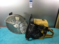 Side view of the saw on a table showing diamond blade, front and rear handles