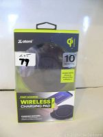 Front view of Atomi wireless fast charging pad in original packaging, showing 10W max output and compatibility.