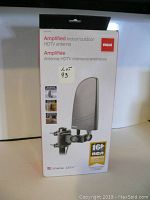 Front view of RCA amplified indoor/outdoor HDTV antenna box showing model and branding.