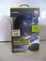 Front view of Atomi Wireless Charging Pad packaging showing product inside, highlighting compatibility and fast charging feature.