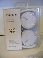 Front of the box with headphones visible inside and Sony branding on the white packaging.