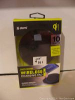 Image of Atomi wireless charging pad in original packaging, showing front label with 10 watts fast charge and compatible devices listed.