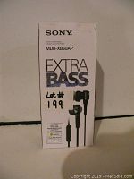 Front side of the box showing Sony branding, model MDR-XB50AP, Extra Bass logo, wired in-ear headphones image and lot number.