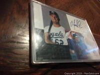 Baseball card featuring Mark Quinn in Kansas City Royals uniform, signed by Mark Quinn, inside a protective plastic case.