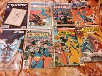 Full view of 8 bagged and boarded vintage Superman comics showing variety of covers.