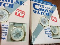 Original Cat and Mouse Watches in box labeled 'As Seen On TV' with illustration of watch featuring cat and mouse and moving mouse second hand.