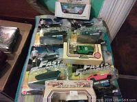 Seven die cast cars with four from Fast and Furious in blister packaging plus three vintage die cast cars including a green Lledo and white T model Ford. Packaging shows wear.