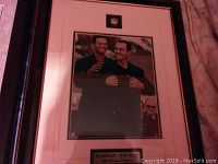 Framed photo showing Mike Weir and Tiger Woods celebrating at the Masters