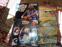 Photo showing Willie and Family Live album cover and other country albums including Hank Williams' greatest hits.