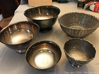 All five silver plated bowls together showing size variation and styles including matching set, basket, and decorative bowl